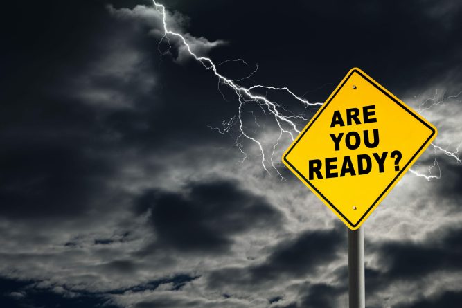 Are You Ready road sign against a dark, cloudy and thunderous sky. Conceptually warning of danger ahead.