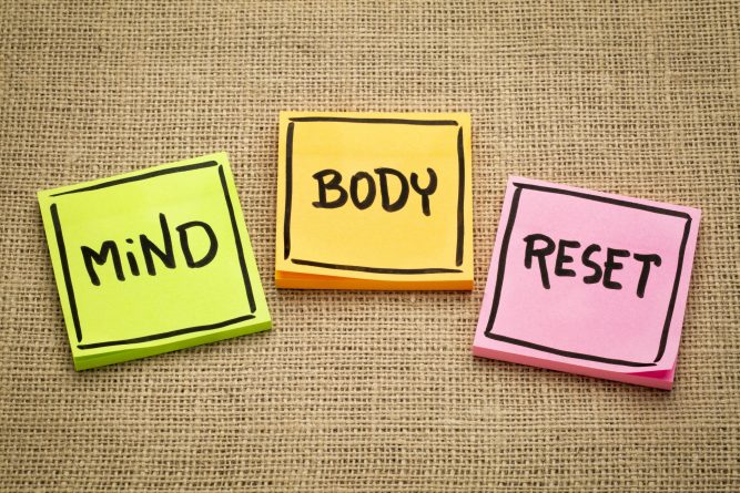 mind and body reset - handwriting on sticky notes against burlap canvas