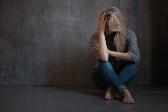 Mental health. Young woman lying on the floor, concept of stress or post-traumatic disorder