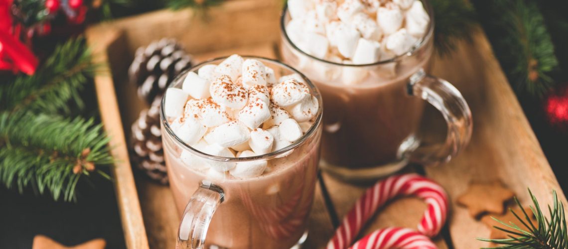 Hot chocolate with marshmallows, warm cozy Christmas drink in a wooden tray