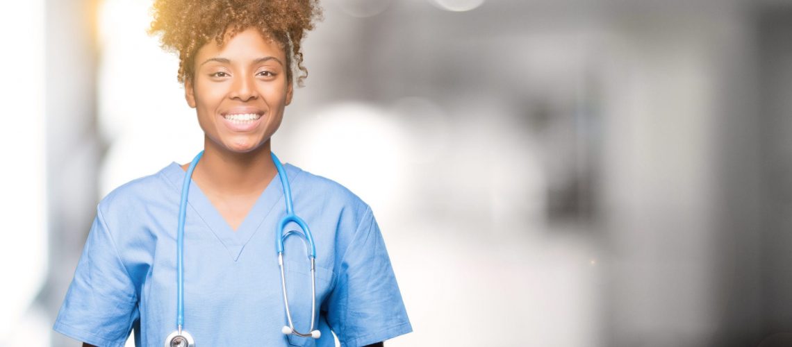 Young african american doctor woman over isolated background Hands together and fingers crossed smiling relaxed and cheerful. Success and optimistic