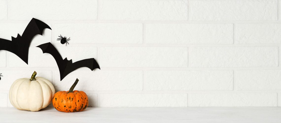 halloween decorations on white brick wall background
