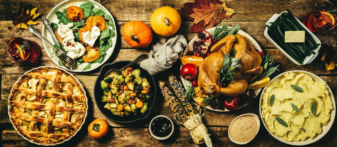 Selection of traditional thanksgiving food - turkey, mashed patatoes, green beans, apple pie on rustic background, top view