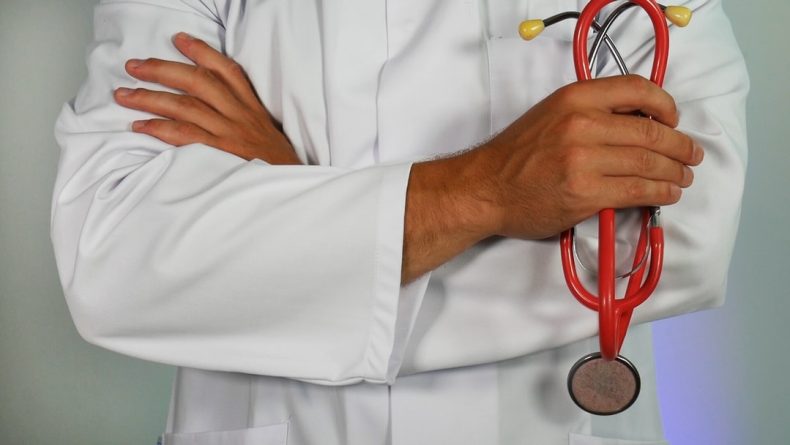 A closeup shot of an urgent care doctor holding a stethoscope.